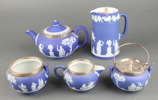 A silver mounted Wedgwood Jasper 3 piece tea set comprising teapot, jug and sugar bowl together with a similar plated mounted jug and sugar bowl 