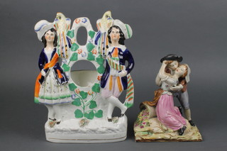 A Victorian Staffordshire watch holders with standing figures of a lady and gentleman 11" together with a ditto group of a lady and gentleman in embrace 7" 