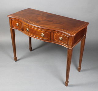 A Georgian style mahogany side table of serpentine outline with satinwood stringing fitted 1 long and 2 short drawers, raised on square fluted supports, spade feet 31"h x 41"w x 18 1/2"d 