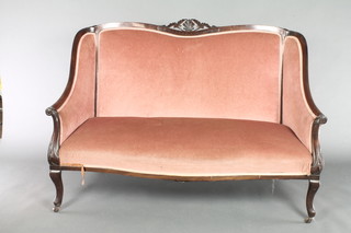 An Edwardian mahogany show frame sofa upholstered in rose pink dralon, raised on cabriole supports
