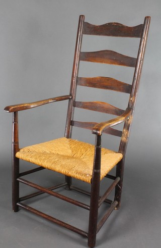 An 18th/19th Century elm ladder back carver chair with woven rush seat