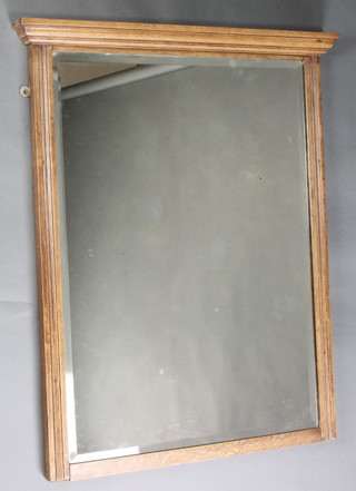 An Edwardian rectangular bevelled plate over mantel mirror contained in an oak frame with moulded cornice 33"h x 27"w 