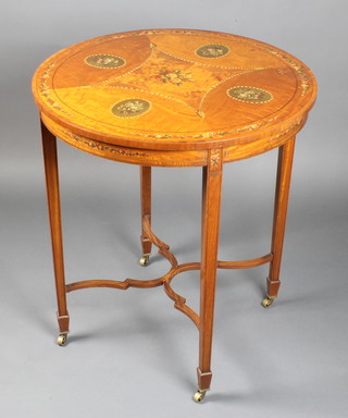 An Edwardian Sheraton revival circular painted satinwood occasional table, the top with painted floral garlands, raised on square tapered supports ending in spade feet  with X framed stretcher 30"h x 27"diam. 
