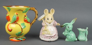 A Wade Heath Art Deco yellow ground jug decorated with parrots 7 1/2", a Beatrix Potter style  bisque figure of a mouse 7", a Sylvac green rabbit 1302 5" and a ditto heron jug 495 2 1/2" 