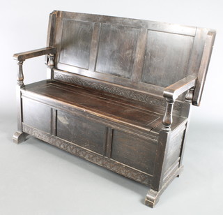 A 19th Century oak monks bench of panelled construction with hinged back, when upright 39"h, when folded down 28"h x 41"w x 18 1/2"d 
