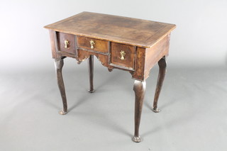 An 18th Century walnut low boy with quarter veneered and feather banded top, fitted 1 long and 2 short drawers, raised on club legs 28 1/2"h x 30 1/2"w x 19"d 