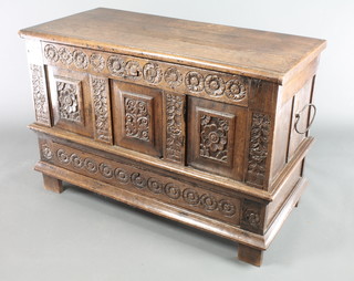 An 18th/19th Century carved oak mule chest of panelled construction, the base fitted a drawer 31"h x 46"w x 21"d 