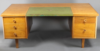Waring & Gillow, a 1950's Ministry of Works kneehole desk with green leather writing surface above pedestals, fitted 3 long and 2 short drawers, raised on square supports 29"h x 72"w x 39"d 