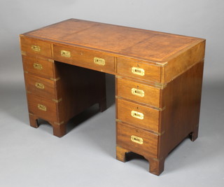 A Military style mahogany kneehole pedestal desk with brown inset writing surface above 1 long and 8 short drawers with brass countersunk handles 30"h x 47 1/2"w x 24"d 