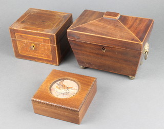 A 19th Century square mahogany and inlaid satinwood caddy with hinged lid 4"h x 6"w x 5"d , a ditto caddy of sarcophagus form raised on bun feet 6" x 8"w x 5"d on brass bun feet (replacement hinges and ivory escutcheon is missing), a Polish wooden box the lid decorated a "wren" 2"h x 5"w x 5"d 