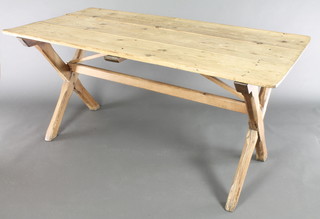 An Arts & Crafts pine trestle table with triple panelled top, raised on X framed supports 29 1/2"h x 61"w x 32"d 