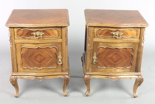 A pair of Kingwood bedside cabinets of serpentine outline, with quarter veneered tops fitted a drawer above a cupboard, raised on cabriole supports 25"h x 18"w x 14"d 