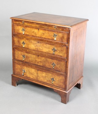 A Queen Anne style walnut chest with feather and crossbanding, fitted a brushing slide above 4 long drawers with brass escutcheons and pear drop handles, raised on bracket feet 32"h x 28"w x 17 1/2"d 