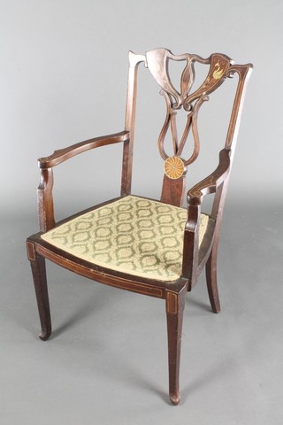An Edwardian inlaid mahogany open arm chair, the seat upholstered in green material, raised on turned supports 