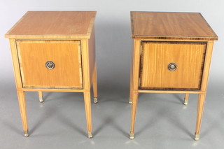 A pair of crossbanded satinwood bedside cabinets enclosed by panelled doors, raised on square tapering supports, brass caps 27"h x 18"w x 18"d 