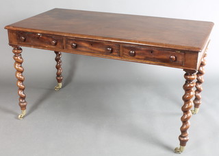 A Victorian rectangular mahogany side table fitted 3 drawers with tore handles, raised on spiral turned supports ending in brass I W Lewty's  caps and castors   28 1/2"h x 52"w x 25 1/2"d