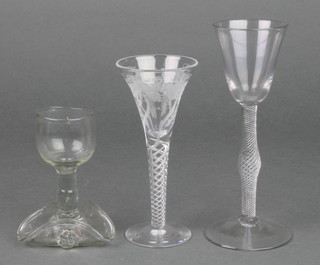An Edwardian liqueur with vinous engraved decoration and air twist stem 5 1/4", a Georgian style ditto with bulbous air twist stem 6 1/4" and a Continental tot with trefoil base 4" 
