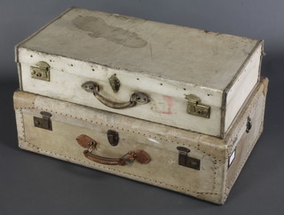 An Au Depart parchment suitcase with brass locks and bearing labels 10"h x 32"w x 20"d and 1 other parchment suitcase, the interior marked Harrods Ltd 7"h x 30"w x 16"d 