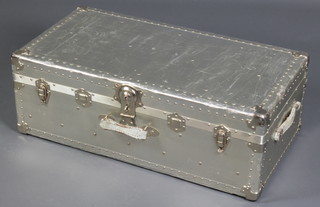 A German polished steel trunk/case 11" x 31 1/2" x 16 1/2", locked and with dents and scratches to the surface