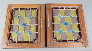 A pair of Art Nouveau Continental oak and lead glazed stained glass panels 28"h x 23"