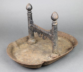 A Victorian iron boot scraper, raised on an oval base 9"h x 14 1/2"w x 12"d 