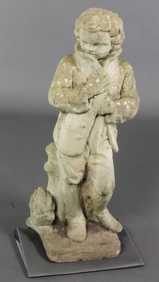 A weathered composition stone figure of a standing chilled boy with coat, raised on a square base 28"