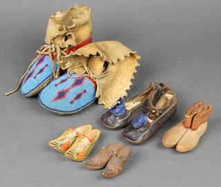 A pair of "native Indian" childs moccasins with blue bead work decoration 6", a pair of 1930's childs slippers, a small pair of leather boots 3" and 2 pairs of wooden clogs 