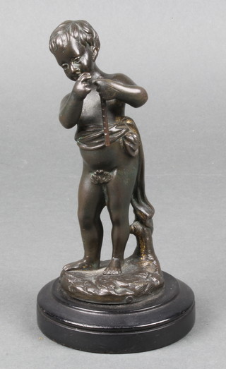 A 19th Century bronze figure of a standing child with flute, raised on a wooden socle base 6" (hole to base) 
