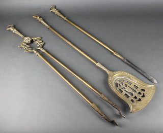 A brass 3 piece fireside companion set with pierced shovel, pair of tongs and poker 