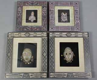 4 various "South American" carved wooden masks contained in carved frames