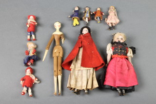 A carved wooden "peg" doll 8", 2 porcelain headed costume dolls and 7 miniature dolls 