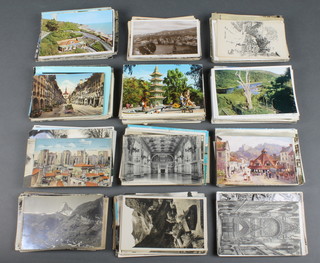 A collection of various black and white and coloured postcards 
