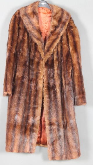A lady's full length brown fur coat, the lining embroidered stylised sunflowers