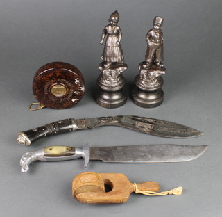A pair of spelter figures in the form of Dutch boy and girl, raised on socle bases 7", a pastry crimper 5", a Chesterman 50' tape measure in a Bakelite case, a reproduction Bowie knife with 10" blade and  Kukri