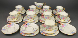 A Tuscan china Art Deco tea set with floral decoration and gilt rims comprising 9 tea cups, 12 saucers, 10 small plates and a cream jug 