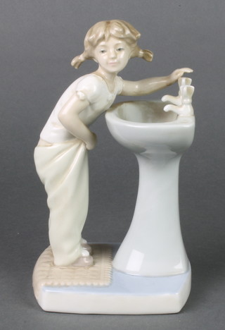 A Lladro figure of a young girl at a wash basin 8" 