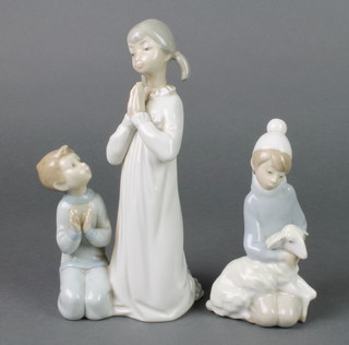 A Lladro figure group of 2 children praying 8 1/2" and a ditto of a young boy with lamb 6" 