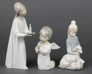 A Lladro figure of a seated praying angel 5", a ditto of a young boy with lamb 6" and a girl holding a chamber stick 8" 