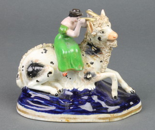 A 19th Century Staffordshire figure of a lady on a reclining goat on a raised base 6" 