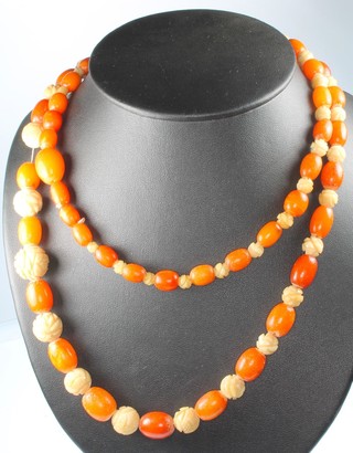 A carved bone and amberoid bead necklace 28" 