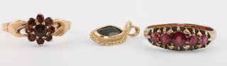 A 9ct garnet set Claddagh ring size L 1/2, a ditto garnet ring size N 1/2 and a garnet pendant