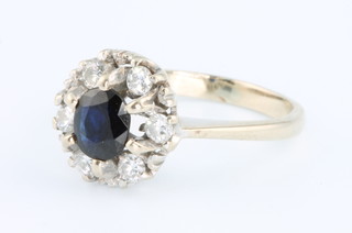 An 18ct white gold sapphire and diamond cluster ring size K