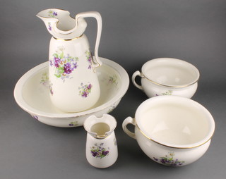 An Edwardian 6 piece wash stand set comprising water jug, bowl, 2 chamber pots and a toothbrush pot decorated with flowers 