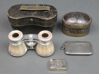 A silver engine turned double vesta, Chester 1922, a silver pill box, a Continental divided box and a pair of mother of pearl opera glasses 