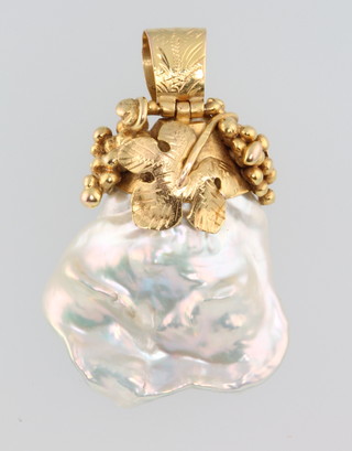 A Baroque pearl pendant in a yellow gold mount with vinous decoration 
