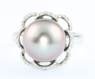 A 1970's 18ct white gold Tahitian black pearl and diamond dress ring, size N