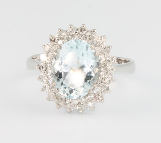 A white gold aquamarine and diamond cluster ring, the centre stone approx. 2.5ct surrounded by brilliant cut diamonds, size N 1/2