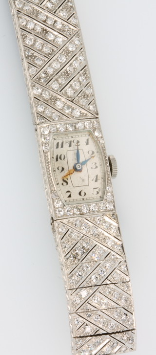 An Art Deco lady's platinum diamond set tablet wristwatch on a silk strap 