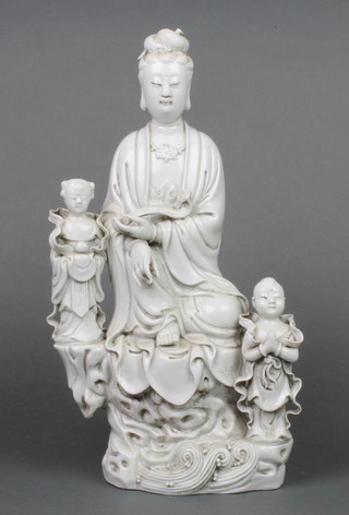 An early 20th Century blanc de chine figure of Guan Yin seated with 2 attendants on a raised base with impressed marks 15" 