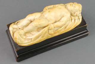 A good 19th Century carved ivory Dieppe figure of a sleeping baby boy on a blanket 5 1/4" raised on an ebonised base